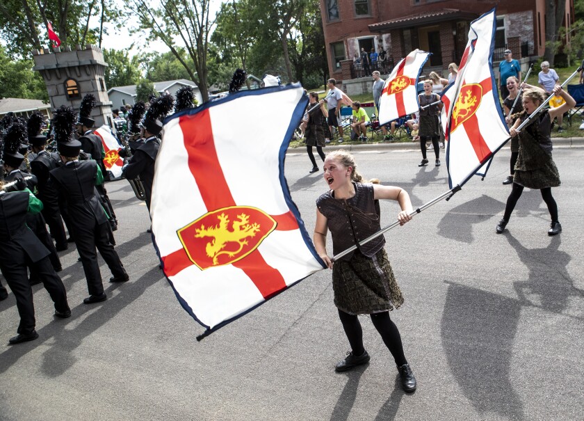 Color guard with the Litchfield Marching Dragons perform along North Armstrong Avenue during the Watercade parade in Litchfield on Saturday, July 9, 2022.