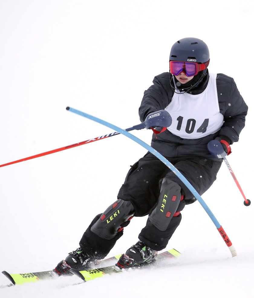Skier races around a gate.