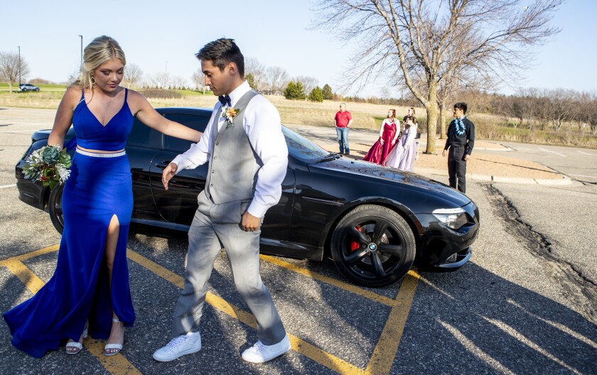 A couple departs their car before walking before hundreds of proud parents and community members during prom at Willmar High School on Friday, May 6, 2022.