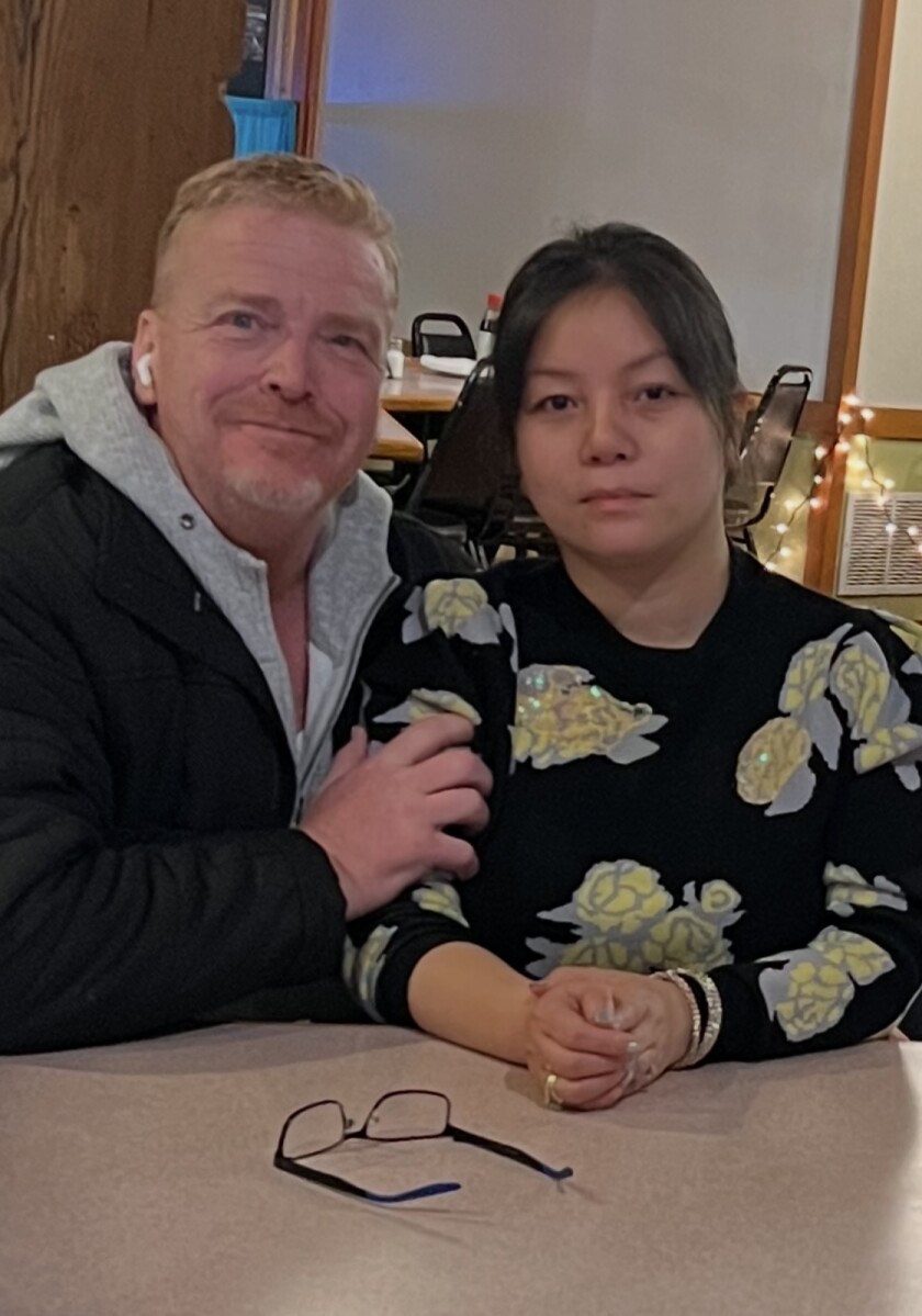 man and woman sit at table