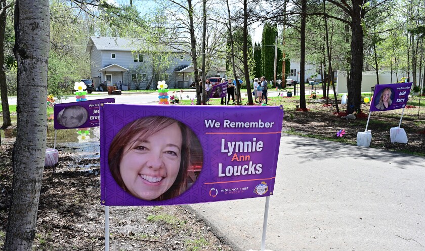 Remembrance signs line a driveway