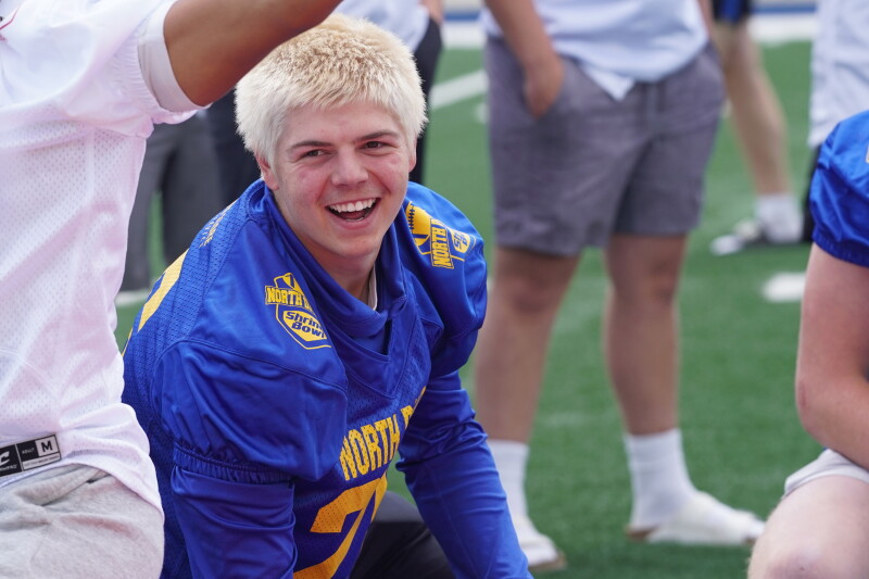Red Lake County's Gunnar Halverson does a baseball-football shuffle for Shrine Bowl