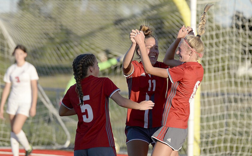 Willmar junior Becca Dawson (5), junior Sophia Quinn (11) and freshman Telilie Lange celebrate after Lange scored a goal in the first half during a Central Lakes Conference game against St. Cloud Apollo on Tuesday, Aug. 30, 2022 at Willmar High School.