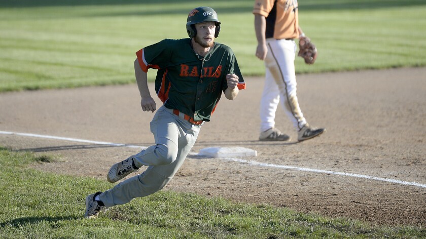 The Willmar Rails' Caleb Owens rounds third and looks to head home before slipping on the wet grass in the 13th inning during a Region 4C elimination game against the Paynesville Pirates on Monday, Aug. 8, 2022 at Green Lake Diamonds in Spicer.