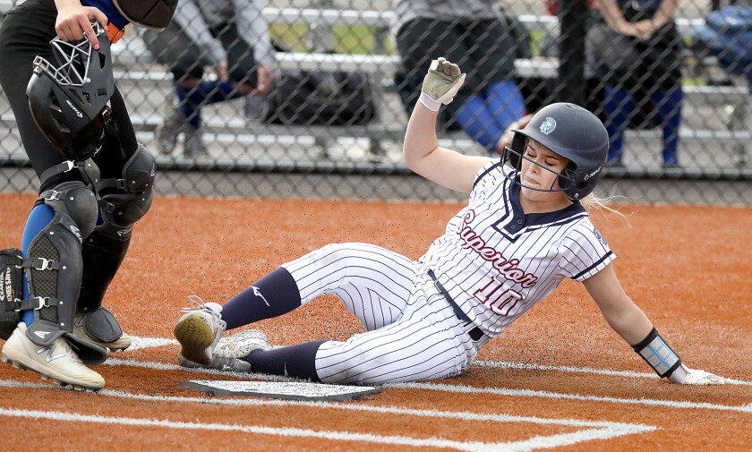 Superior’s Paige Johnson (10) slides safely into home