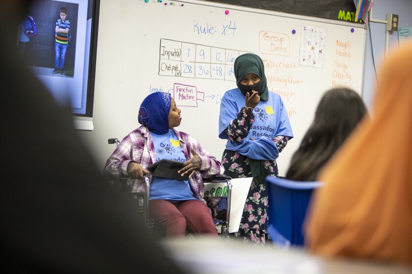 Hana Mahamud, 18, from left, and Deqa Mohamed, 19, speak to the fourth-grade classroom of Lisa Devine at Kennedy Elementary School about bullying on Thursday, May 5, 2022.