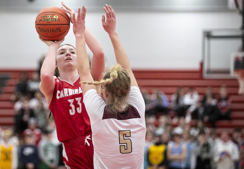 Willmar senior Ella Shinn shoots past Ellie Colbeck of Fergus Falls as the Cardinals played host to the Fergus Falls Otters Feb. 17, 2022.