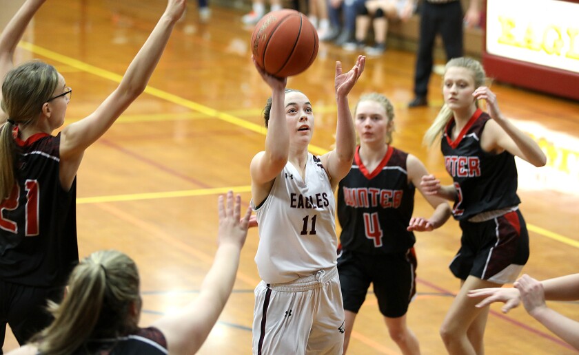 Solon Springs’ Kyra Latvala (11) gets off a shot in the middle of the Winter defense