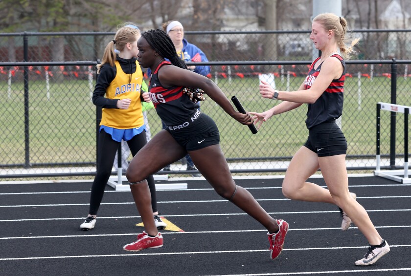 Worthington Trojans Bailey Newman hands off to Pham Gora in the girls 4x100 relay during the Worthington Trojans Invite Thursday afternoon.
