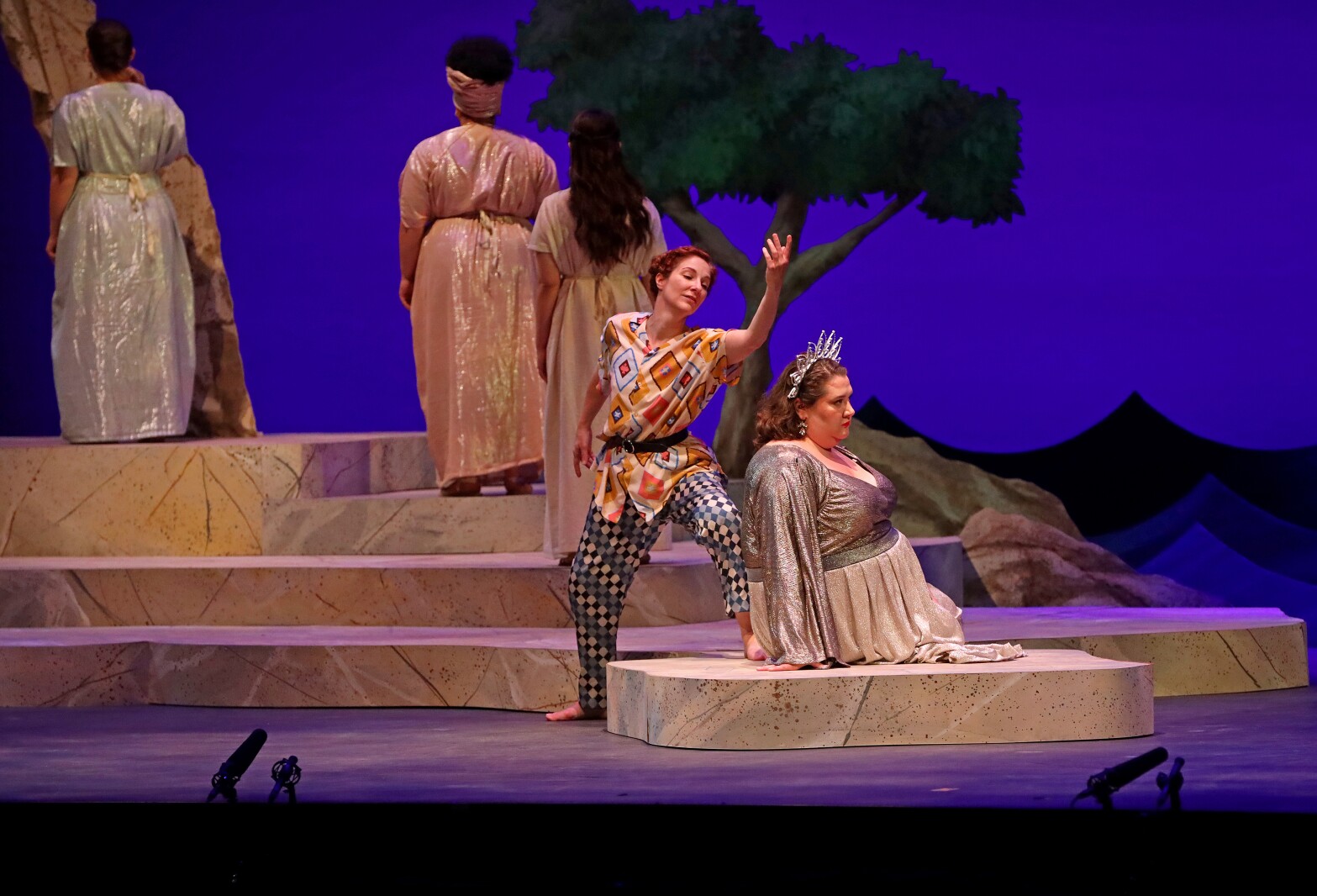 Actors perform on stage.