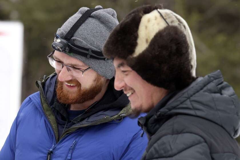 Two mushers talk.