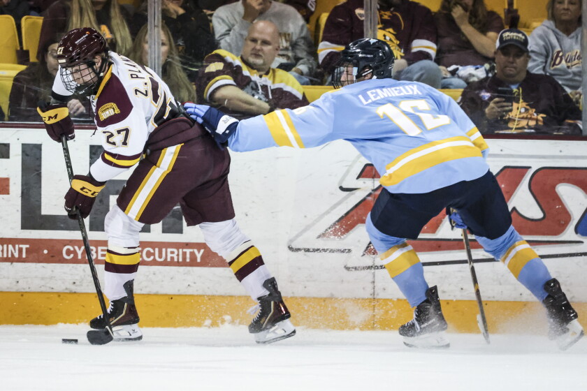 college men play ice hockey indoors