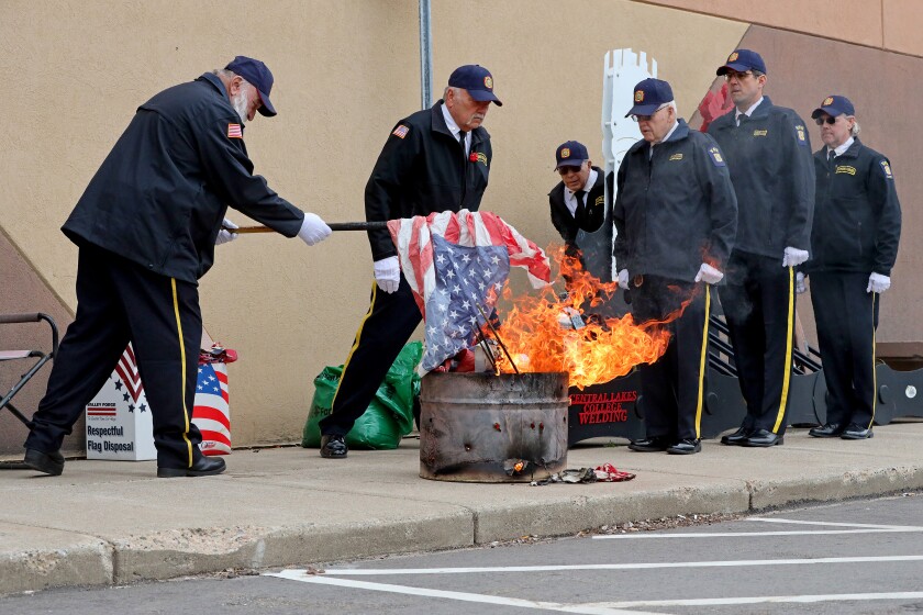 Retiring the flag with grace and dignity, the Brainerd Honor Guard performs a flag ceremony that involves burning old and damaged flags in a respectful manner.