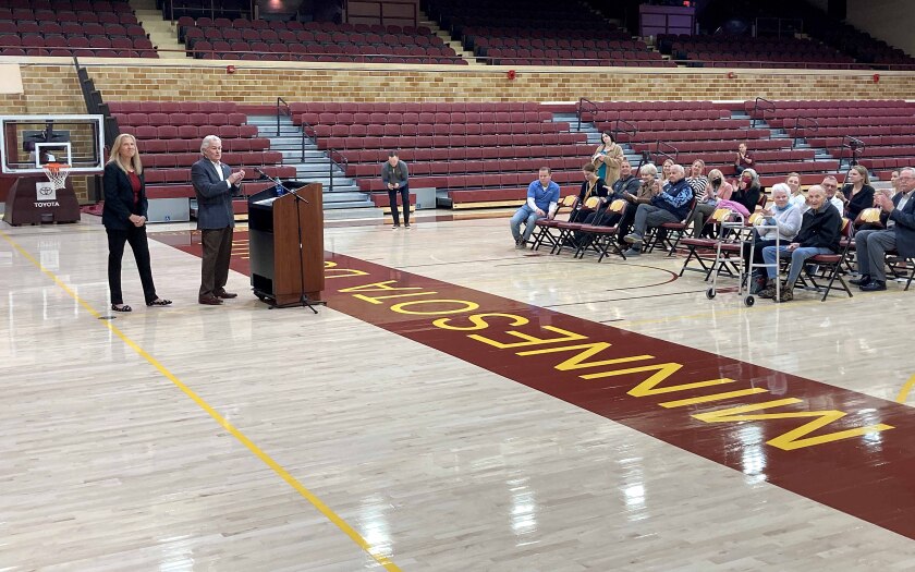 Karen Stromme and Gary Holquist standing at a podium in front of an audience