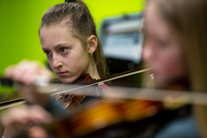 Averie Turner, 14, of Spicer plays along with instructor Dempsey Schroeder at Hope Lutheran Church in Sunburg Sunday, April 3, 2022, during a fiddle workshop.