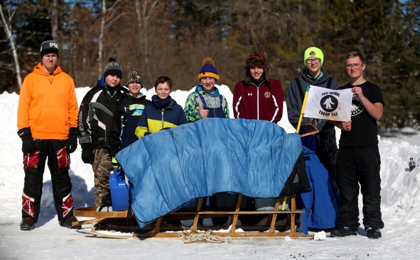 children standing near a sled