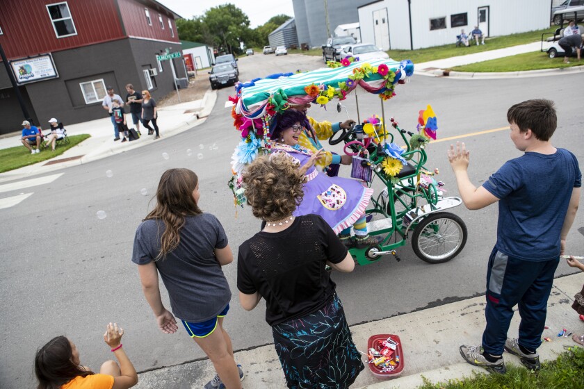 The clown car of "Cup Cake" and "Flap Jack" passes by parade attendees as they watch Saturday's Lake Lillian Fun Days parade on August 6, 2022.