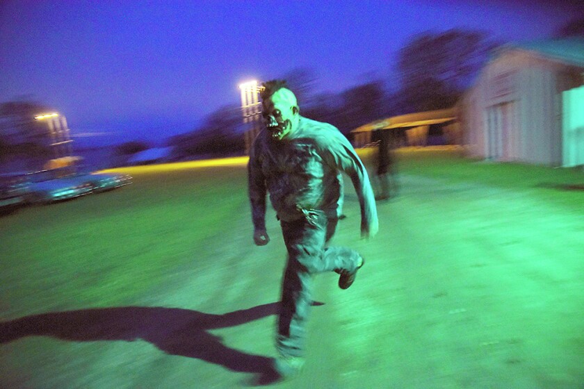Briana Sanchez / TribuneMat Gomez chases after people once they exit the Deegers Freak Show haunted house Sunday night. The haunted house was put on by the Willmar Noon and Nite Lions. Regular admission is $10. Admission is $8 with the donnation of a canned food item for the Willmar Area Food Shelf.
