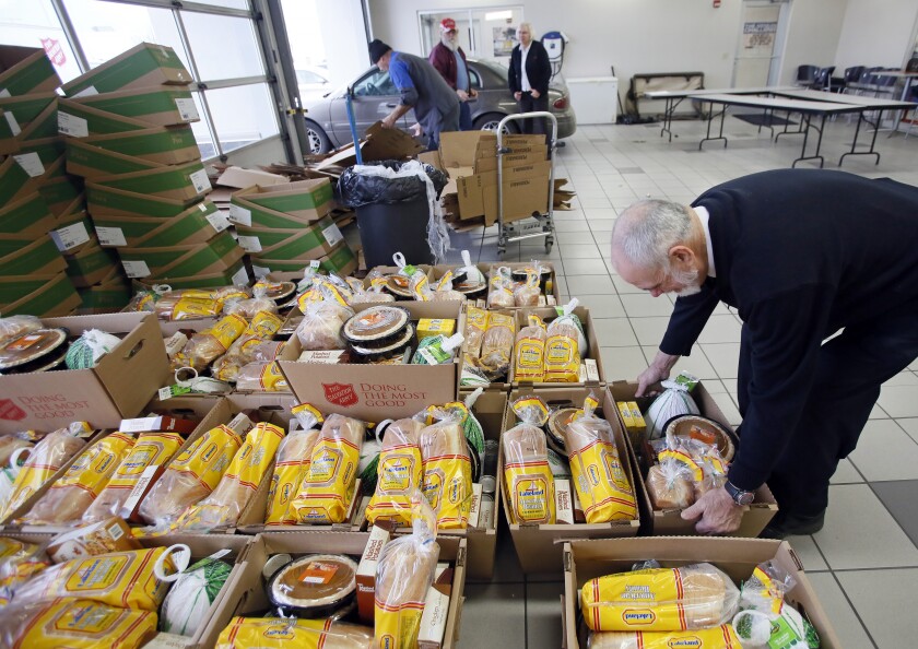 Food baskets are assembled for the Salvation Army's turkey basket give away at Luther Family Ford in south Fargo on Monday, Nov. 20, 2017. David Samson / The Forum