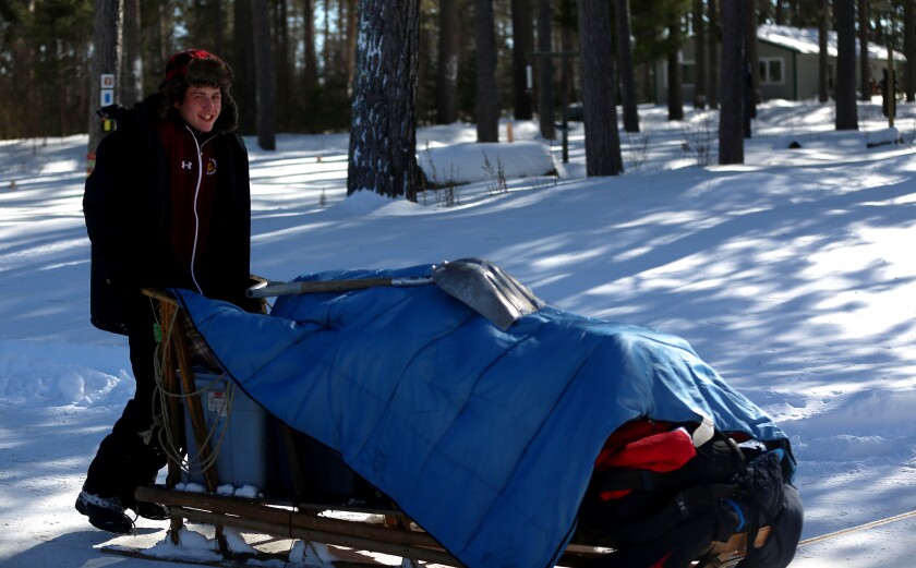 boy riding a sled