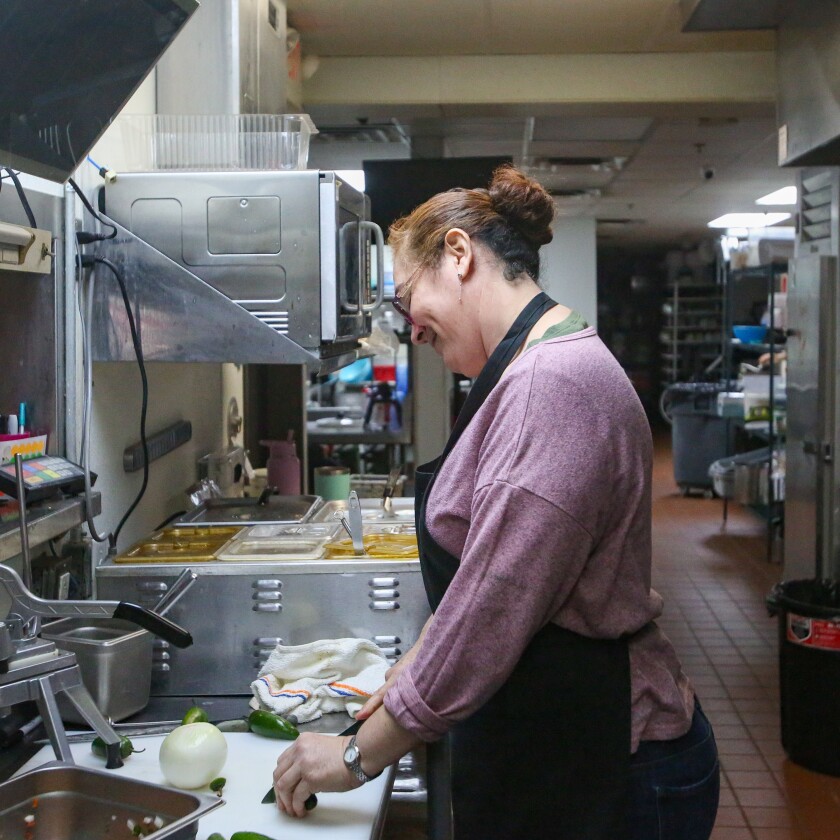 Maria Vazquez slices jalapeños for a California Burrito "Maria's Way" on Monday, Nov. 17, 2025, at El Valle Taco Shop in Casselton.