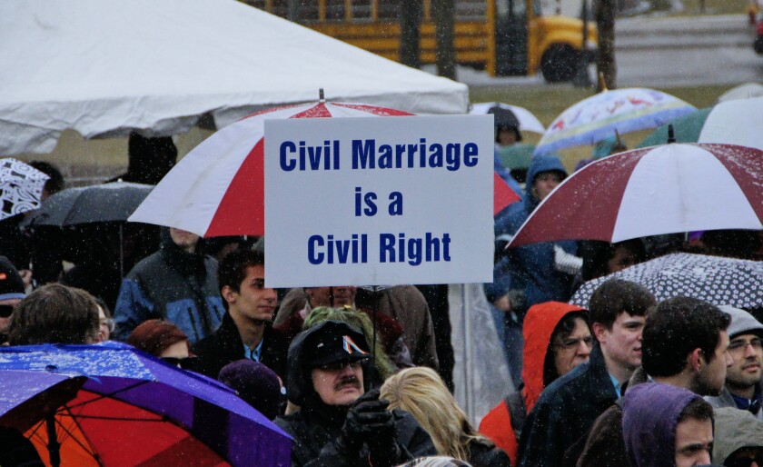 A man holds a sign during a rally
