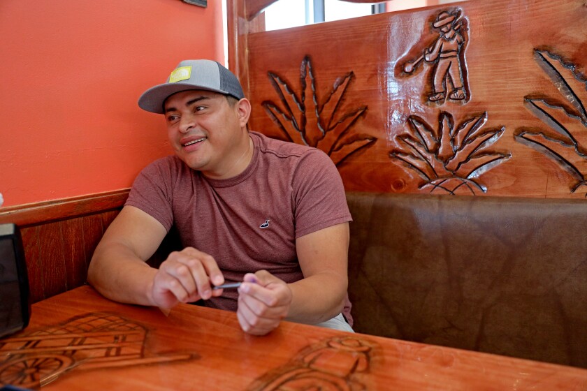 Man sits in booth at restaurant