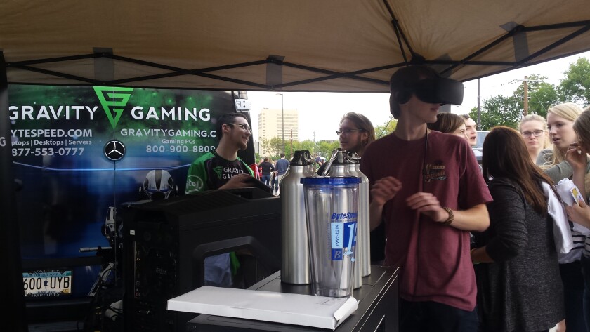 Zane Voglewede, a Minnesota State University Moorhead freshman from Fargo, turns while wearing a virtual reality headset brought to the Moorhead Business Association's Bridge Bash on Thursday, Sept. 8, by Gravity Gaming. Josie Gereszek/The Forum