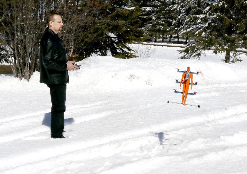 Ascend Dynamics, LLC founder, Daniel Gant, flies a smaller prototype of his SkyPak, a propeller-driven jetpack, outside of his workshop