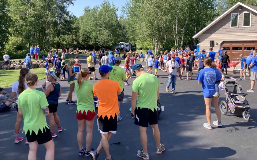 People gathered in a driveway ahead of a race