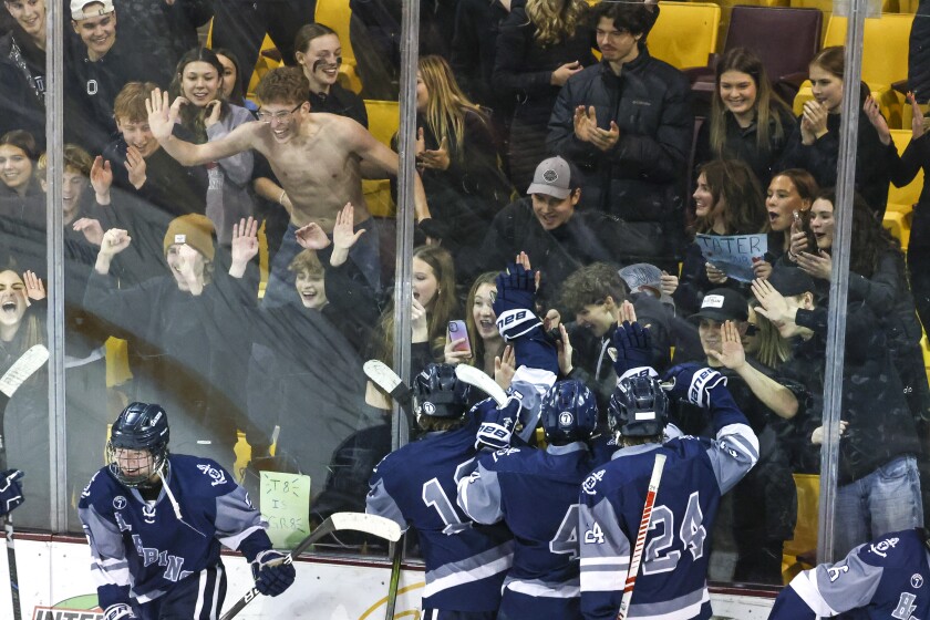 high school boys play ice hockey