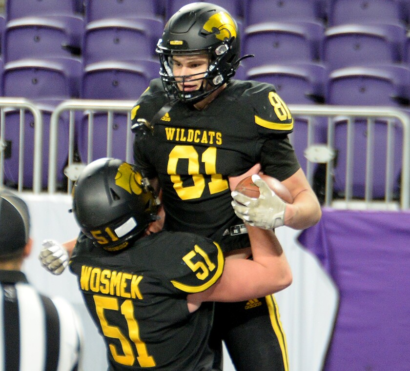 NLS senior Brycen Christensen, 81, is lifted up by senior Luke Wosmek after scoring a touchdown during the Class AAA state semifinals against Watertown-Mayer on Saturday, Nov. 19, 2022 at U.S. Bank Stadium in Minneapolis.