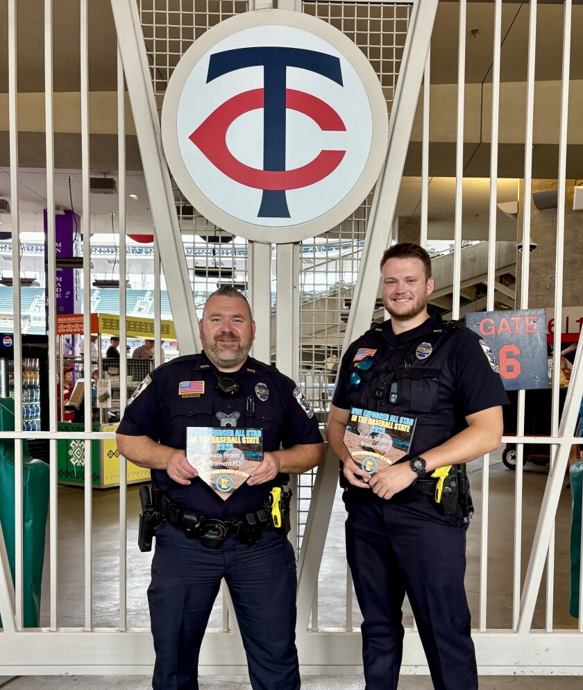 Two men in uniform standing next to a gate.