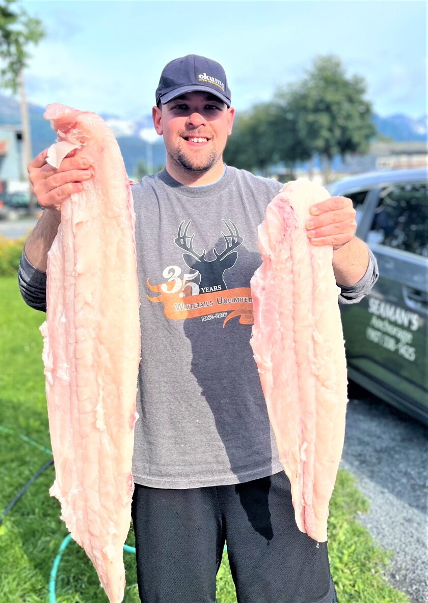 David Rokser holding halibut fillets