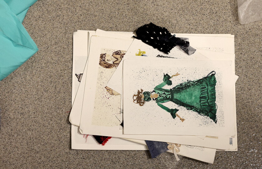 Art sketches lay on the ground.