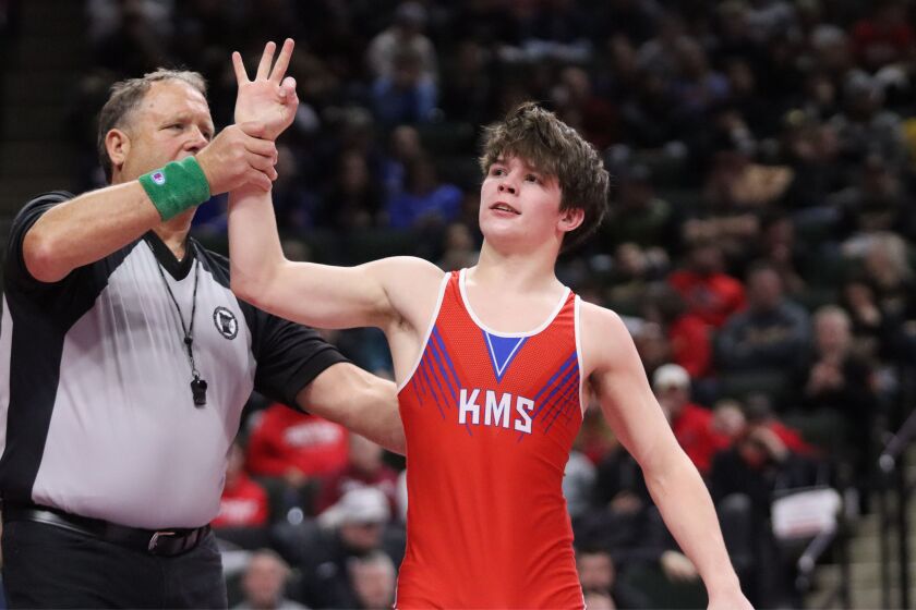 KMS junior Trey Gunderson holds up three fingers after beating Westfield's Bo Zwiener in the Class A 139-pound championship match on Saturday, March 1, 2025, at the Xcel Energy Center in St. Paul. Gunderson won by tech fall, 18-1, to win his third straight state title.