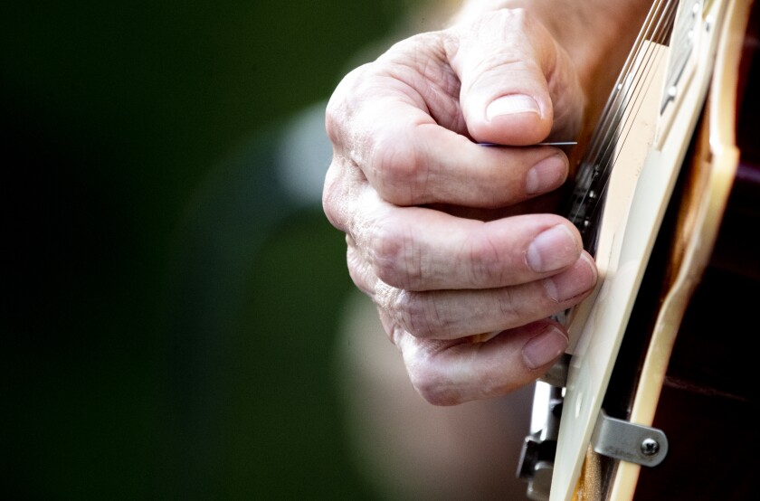 Xpedition lead guitarist Randy Keeley strums along during the first Rockin' Robbins event of the summer season at Robbins Island Regional Park in Willmar on Tuesday, July 12, 2022.