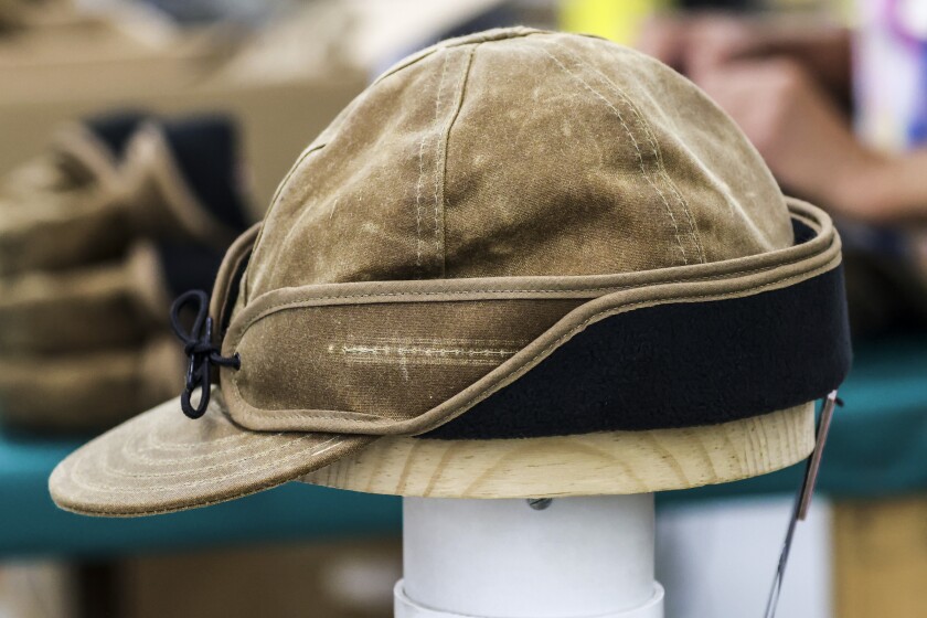 Wool caps with ear bands being made in factory