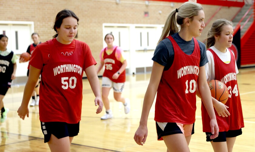 Worthington Trojans (from left) Madison Beckmann, Tarren Spartz and Regan Schaefer move to the next drill set during a Tuesday afternoon basketball practice.