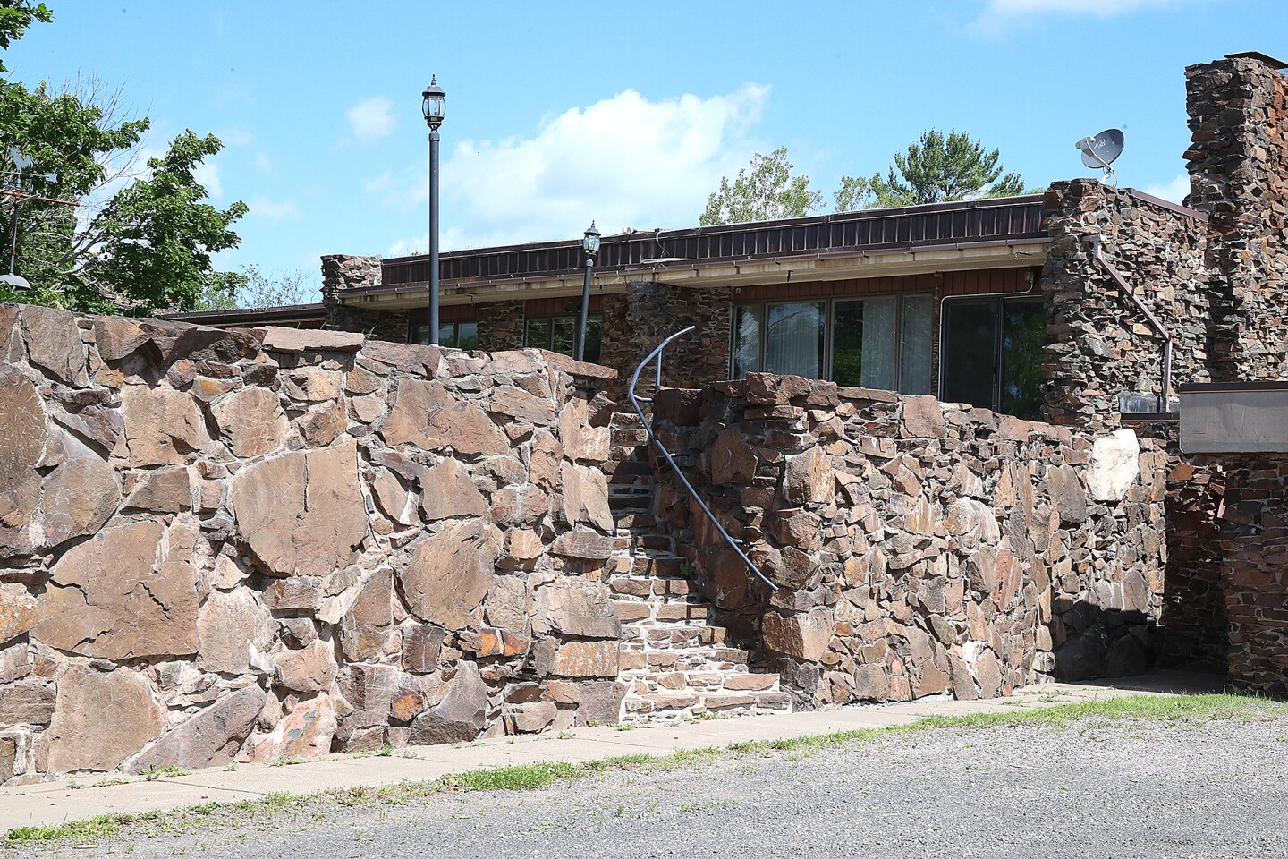 Stone wall in front of house.