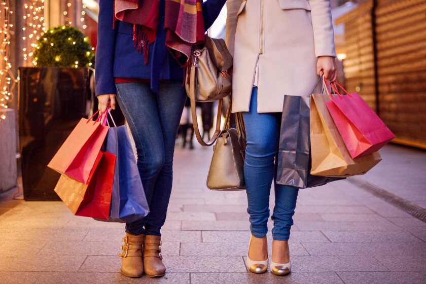 Tech Savvy: Holiday Shopping Deals Are Here — And Early - Brainerd Dispatch 44 In a photo illustration, two shoppers walk next to each other with multiple bags in hand.