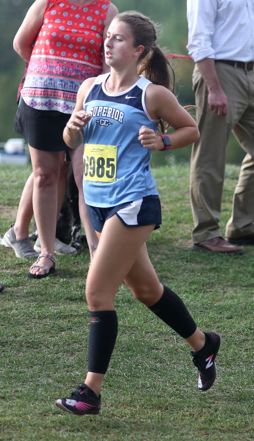 Superior’s Savannah Leopold (6985) runs down a hill during the John Woodbury Invitational