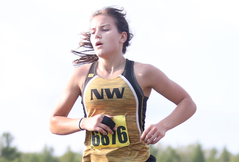 Northwestern’s Ashlyn Sutherland (6876) runs to a fourth place finish