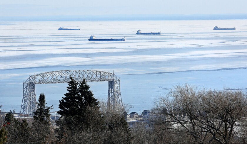 Four of eight freighters at anchor on Lake Superior offshore from Duluth on Monday afternoon make a picturesque scene with the Aerial Lift Bridge. Bob King / rking@duluthnews.com