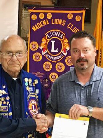 Dr. Ryan Anderson, right, presented John Edingr with a certificate commemorating 60 years as a member of the Lions Club. Courtesy photo.