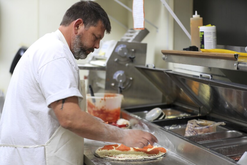 Man working in pizza restaurant