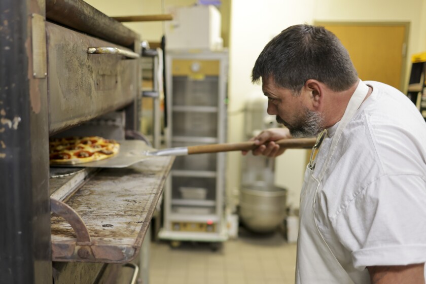 Man working in pizza restaurant