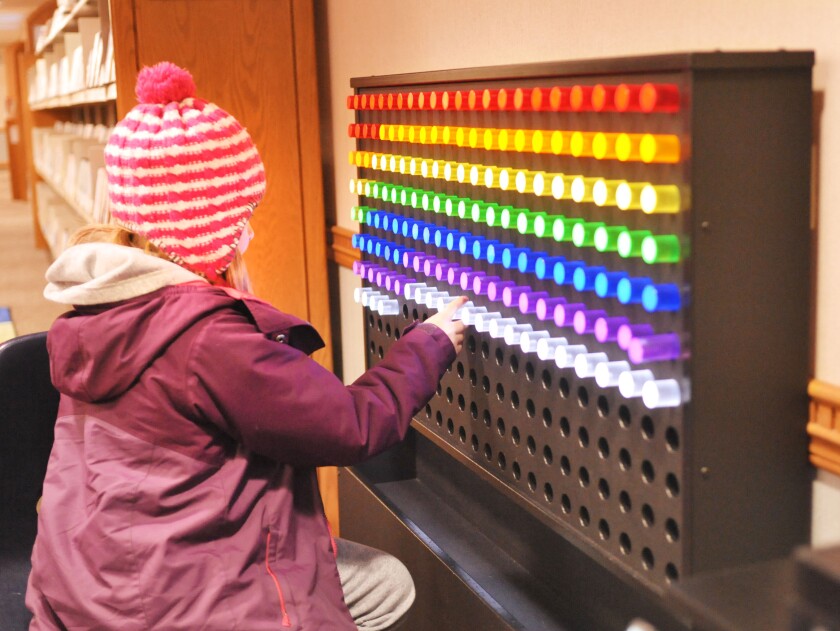 child playing with light board