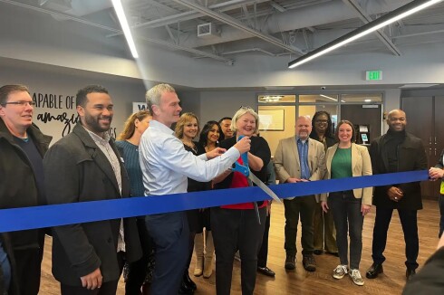 95b509-20250203-a-group-of-people-smile-and-cut-a-ribbon-webp1400.jpg