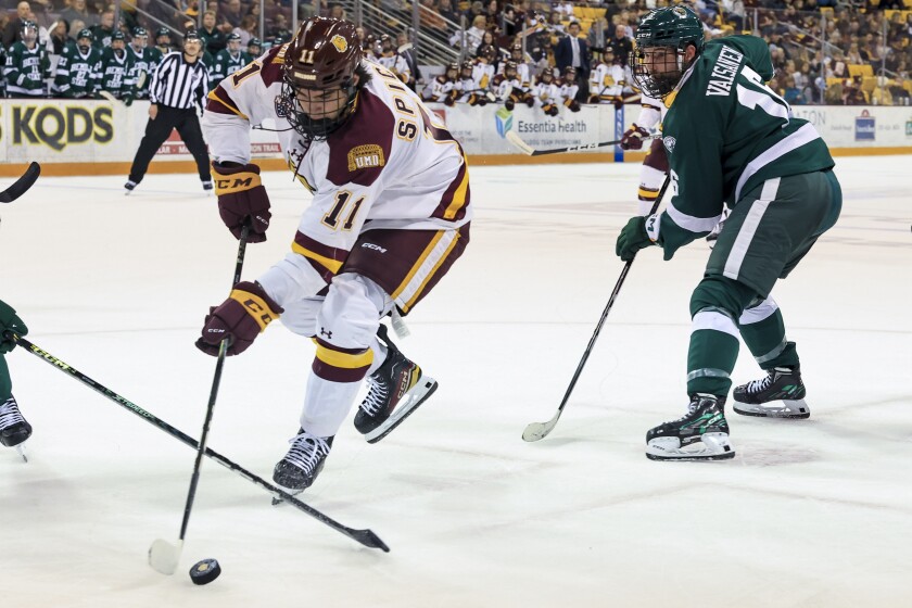 college men play ice hockey